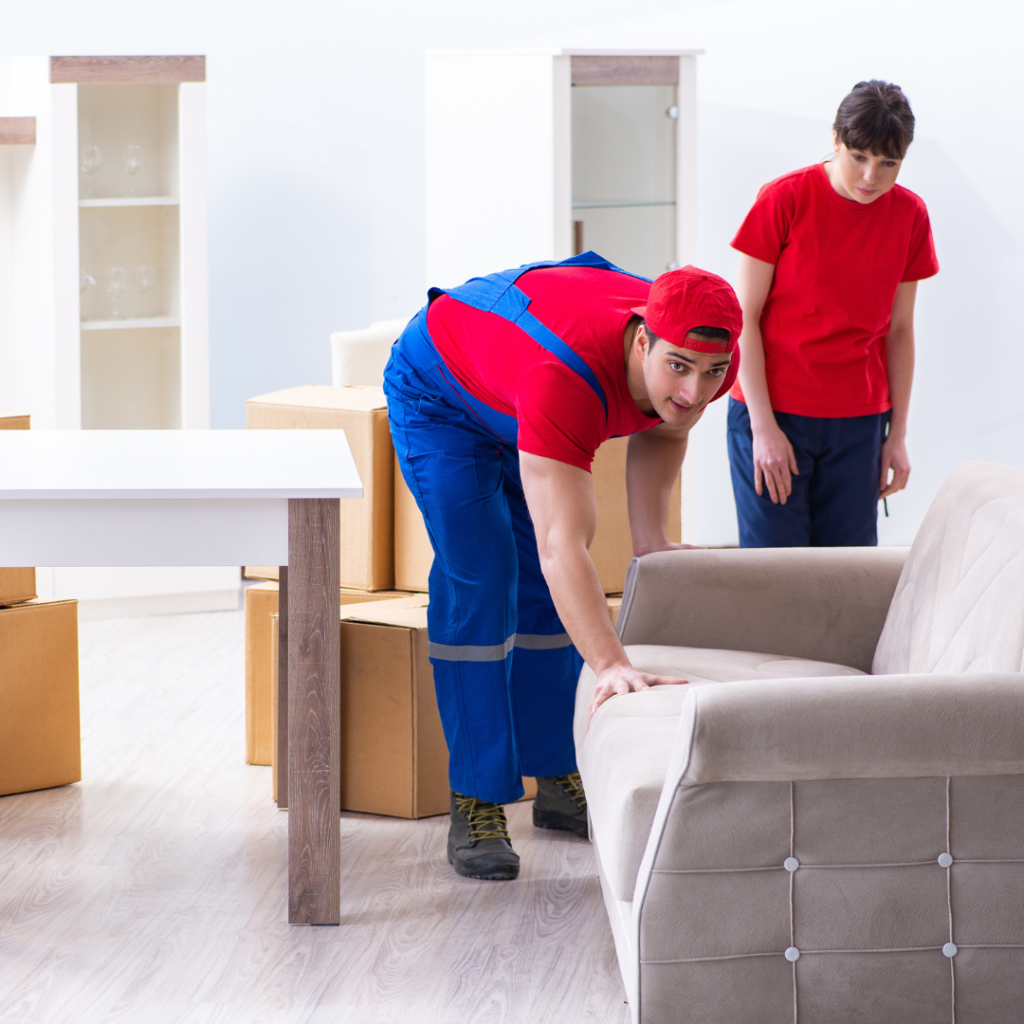 Professional movers and packers in Dubai lifting furniture during a relocation.